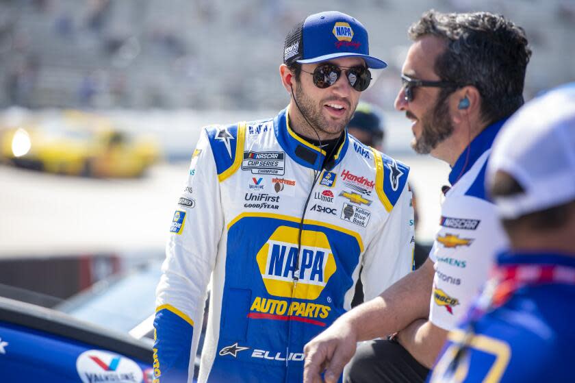 Chase Elliott (9) talks with his team during NASCAR Cup Series practice at Dover Motor Speedway.