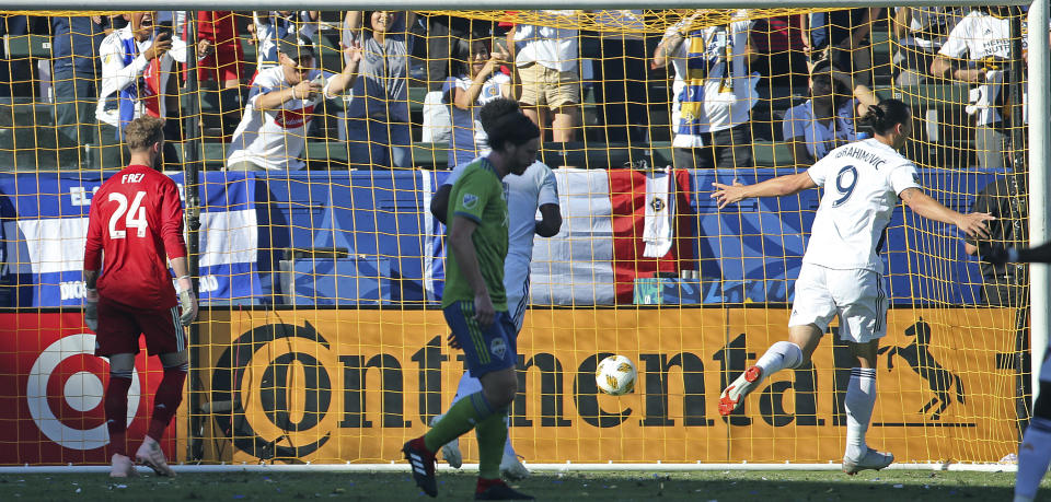 LA Galaxy forward Zlatan Ibrahimovic (9) scores a goal on Seattle Sounders goalkeeper Stefan Frei (24) in the first half of an MLS soccer match in Carson, Calif., Sunday, Sept. 23, 2018. (AP Photo/Reed Saxon)