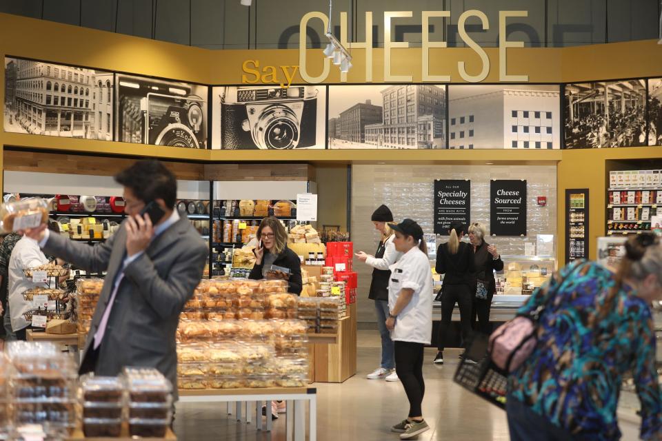 Photos line the wall of Kodak's history in Rochester mixed with a play on cheese above the cheese department is displayed at Whole Foods Market.  The first store in the Rochester area.