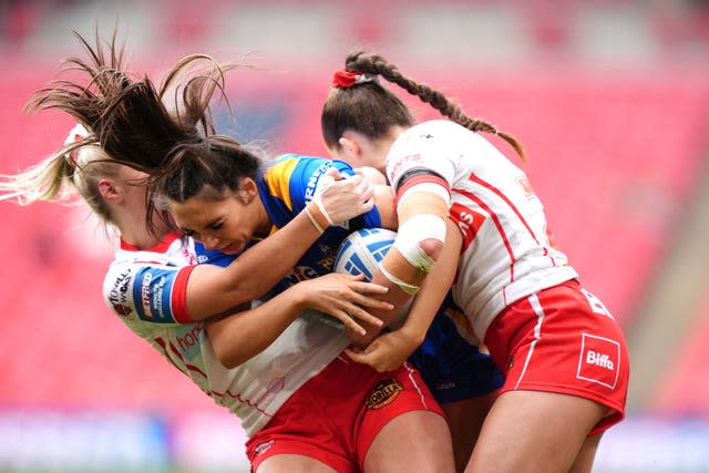 Two St Helens players tackle a Leeds player with the ball at Wembley