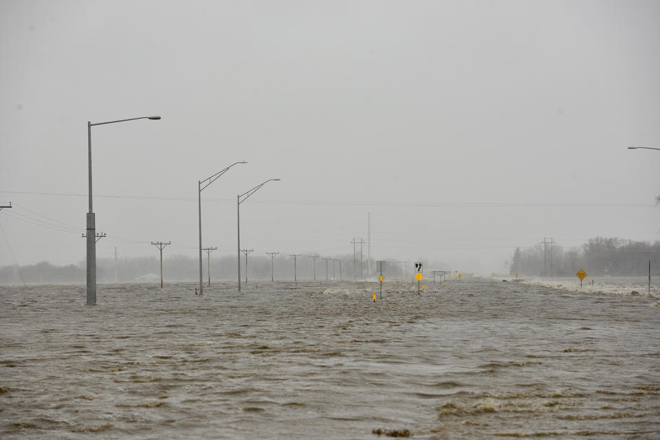 In this March 14, 2019 photo, Highway 81 north of Norfolk, Neb., is covered in flood waters. Thousands of people have been urged to evacuate along eastern Nebraska rivers as a massive late-winter storm has pushed streams and rivers out of their banks throughout the Midwest. (Darin Epperly/The Norfolk Daily News via AP)