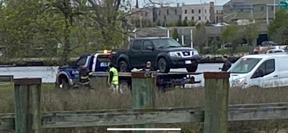 A flatbed truck holds the pickup pulled from the water early Thursday at Bold Point Park in East Providence.