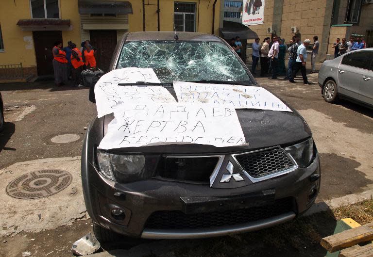 A damaged car covered in posters reading "Dadayev is a victim of outrage!", referring to Zaur Dadayev, one of the two Chechens officially accused of the murder of Russian opposition activist Boris Nemtsov