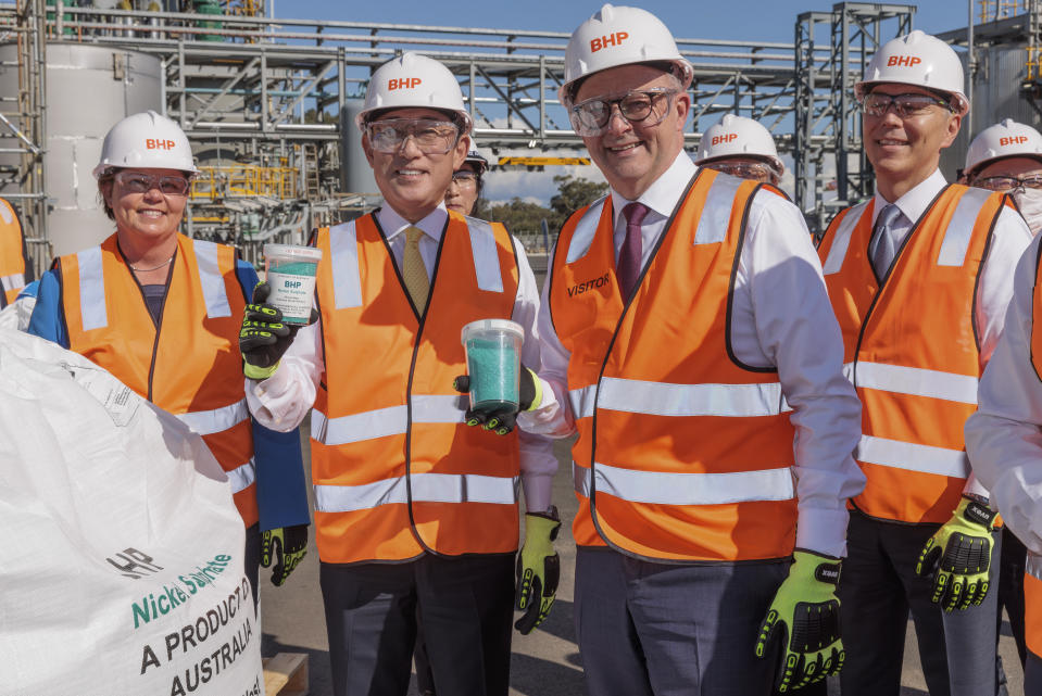 Japan's Prime Minister Fumio Kishida, center left, and Australian Prime Minister Anthony Albanese, center right, hold jars of nickel sulphate during a visit to BHP Nickel West Kwinana Nickel Refinery near Perth, Australia, Saturday, Oct. 22, 2022. Kishida is on a visit to bolster military and energy cooperation between Australia and Japan amid their shared concerns about China. (Richard Wainwright/Pool Photo via AP)