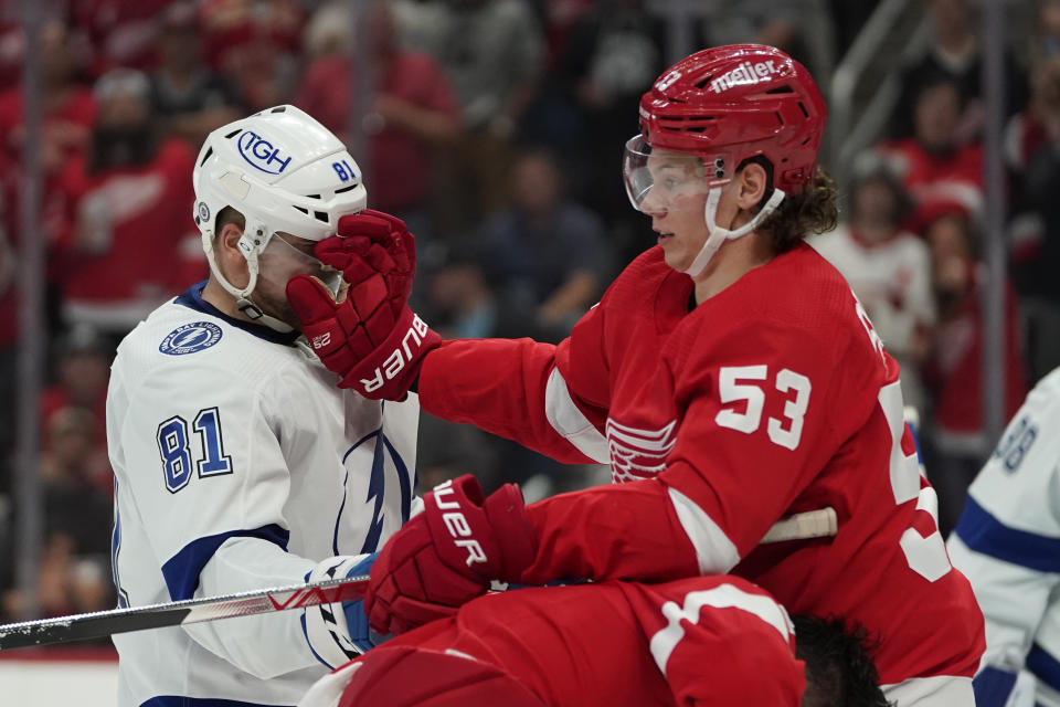 Detroit Red Wings defenseman Moritz Seider (53) gives Tampa Bay Lightning defenseman Erik Cernak (81) a face wash during scrum in the second period of an NHL hockey game Thursday, Oct. 14, 2021, in Detroit. (AP Photo/Paul Sancya)