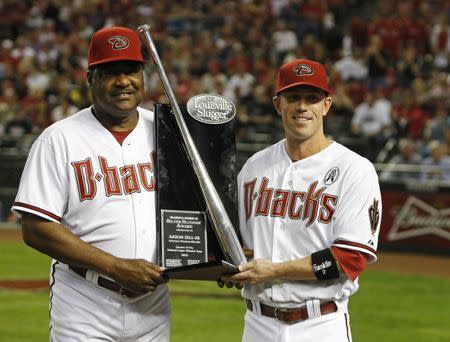 Arizona Diamondbacks' Aaron Hill (R) is presented the Silver Slugger Award by hitting coach Don Baylor before the start of their MLB Opening Day National League baseball game against the St. Louis Cardinals in Phoenix, Arizona April 1, 2013. REUTERS/Ralph D. Freso