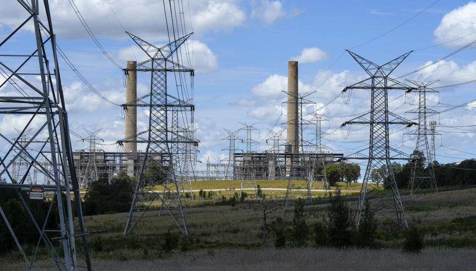 Power lines lead from the Liddell Power Station, a coal-powered thermal power station near Muswellbrook in the Hunter Valley, Australia on Nov. 2, 2021. Australia’s new government on Thursday formally committed to a more ambitious greenhouse gas reduction target of 43% by the end of the decade in fulfillment of a key election pledge. ( AP Photo/Mark Baker)