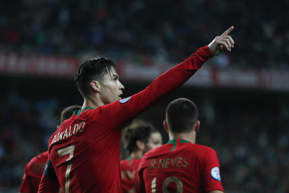 Portugal's Cristiano Ronaldo celebrates after scoring the opening goal during the Euro 2020 group B qualifying soccer match between Portugal and Lithuania at the Algarve stadium outside Faro, Portugal, Thursday, Nov. 14, 2019. Ronaldo scored a hat trick in Portugal's 6-0 victory. (AP Photo/Armando Franca)