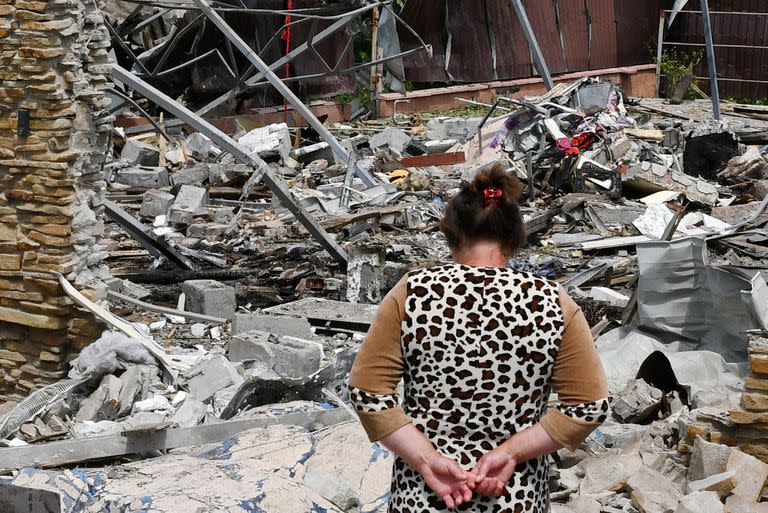 Una mujer camina junto a una vivienda destruida durante un ataque con misiles, el miércoles 1 de junio de 2022, en Sloviansk, Ucrania. (AP Foto/Andriy Andriyenko)