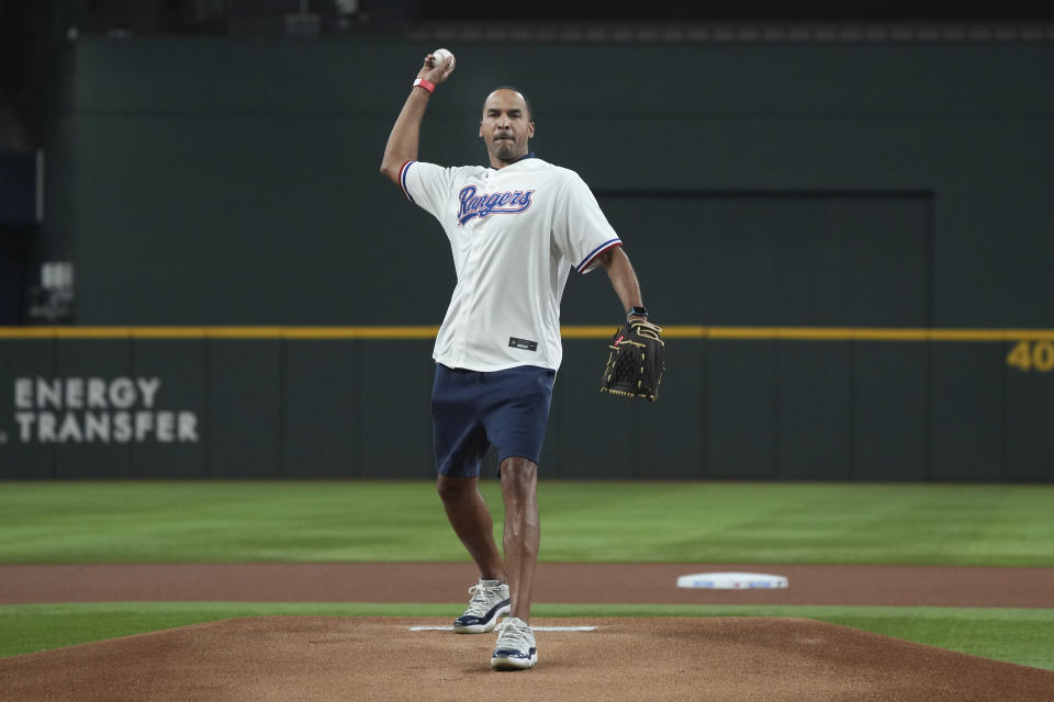 Dallas Mavericks general manager Nico Harrison throws out the first pitch before a baseball game between the Detroit Tigers and the Texas Rangers in Arlington, Texas, Wednesday, June 28, 2023. (AP Photo/LM Otero)