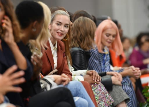 Actress Emily Blunt (C) was among the celebrities eyeing Tory Burch's designs during the runway show at the Brooklyn Museum