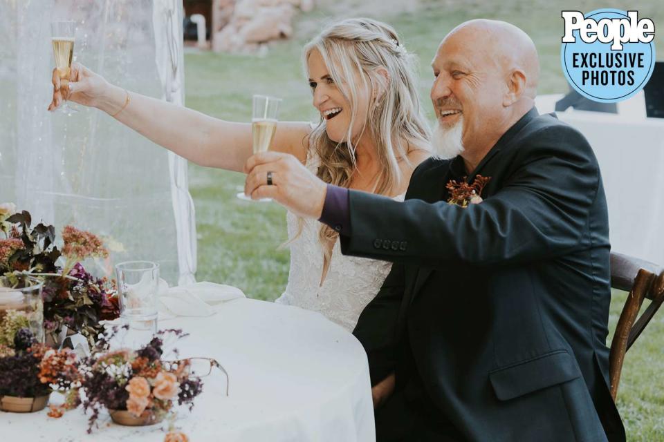 <p>Dani Sork Photo</p> Christine Brown and David Woolley celebrate at their wedding.