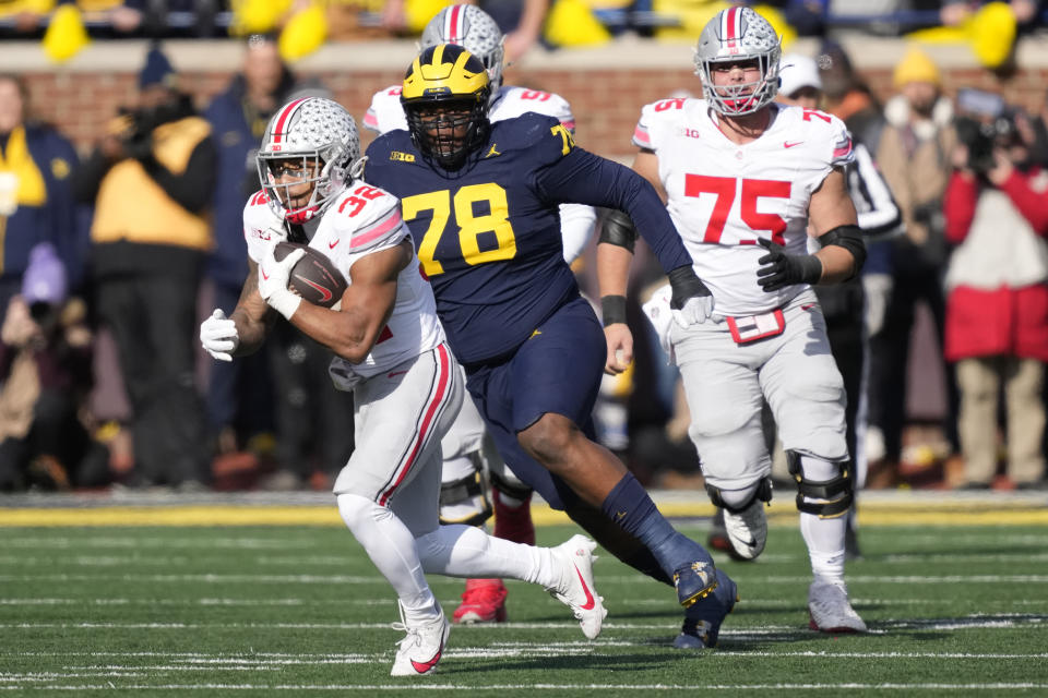 Ohio State running back TreVeyon Henderson (32) rushes during the first half of an NCAA college football game against Michigan, Saturday, Nov. 25, 2023, in Ann Arbor, Mich. (AP Photo/Carlos Osorio)