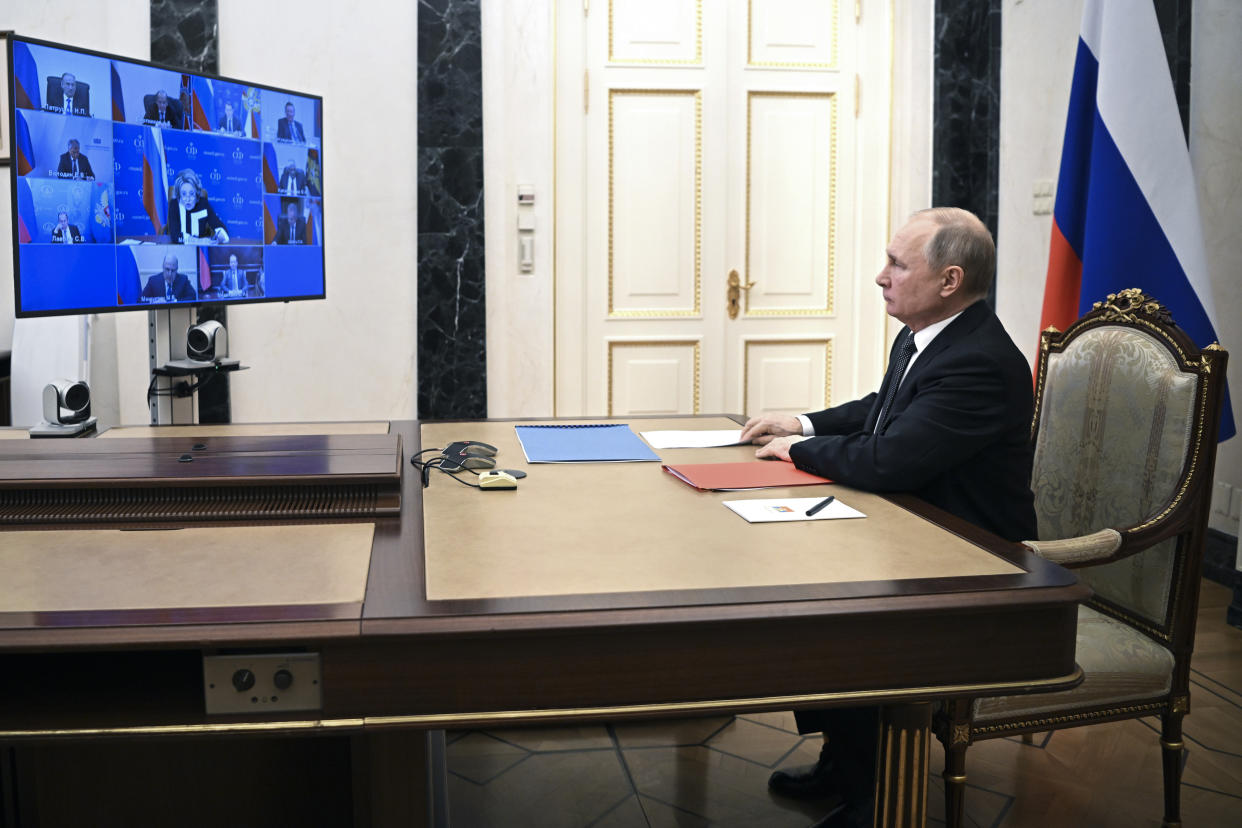 Russian President Vladimir Putin chairs a Security Council meeting via video conference at the Novo-Ogaryovo residence outside Moscow, Russia, Friday, Feb. 18, 2022. (Mikhail Klimentyev, Sputnik, Kremlin Pool Photo via AP)