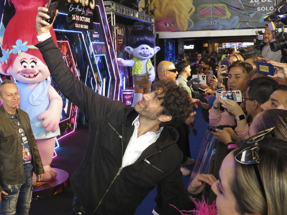 El actor y cantante mexicano Benny Ibarra, se toma selfies con fans en la alfombra roja de la película animada Trolls Band Together en la Ciudad de México el domingo 15 de octubre de 2023. Ibarra hace la voz en español del personaje Ramón, conocido en inglés como Branch. (Foto AP/Berenice Bautista)