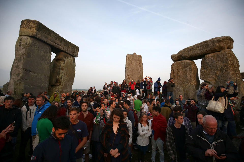 <p>Revellers watch the sun rise on the stones of the Stonehenge monument on the summer solstice near Amesbury, Britain, June 21, 2017. (Photo: Neil Hall/Reuters) </p>