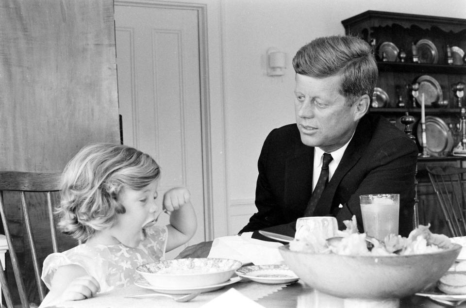 <p>Senator John F. Kennedy sitting with Caroline as he goes over some papers at the kitchen table in his Georgetown home. He had recently been nominated as the presidential candidate for the Democratic Party.</p>