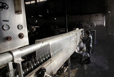 A worker monitors empty bottles on the bottling line at the Murree brewery in Rawalpindi, Pakistan March 13, 2017. REUTERS/Caren Firouz