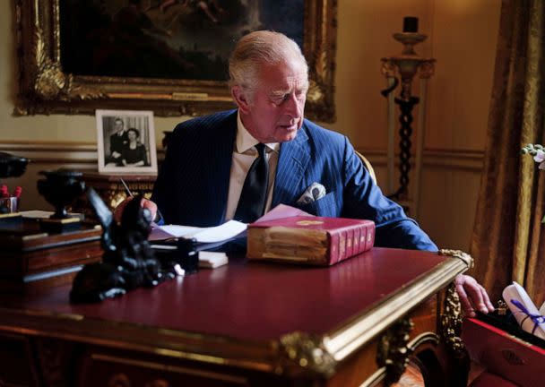 PHOTO: In this photo taken Sept.  11, 2022, Britain's King Charles III carries out official government duties from his red box in the Eighteenth Century Room at Buckingham Palace, London.  (Victoria Jones/PA via AP)