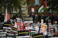 People hold placards and Palestinian flags as they march in solidarity with the Palestinian people amid the ongoing conflict with Israel, during a demonstration in London, Saturday, May 15, 2021.(AP Photo/Alberto Pezzali)