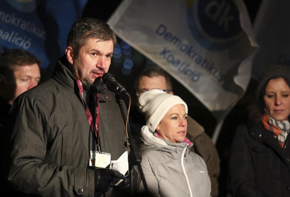 Independent MP Akos Hadhazy, left, delivers his speech during the rally held against the government in front of the headquarters of the public broadcaster MTVA in Budapest, Hungary, Monday, December 17, 2018. (Balazs Mohai/MTI via AP)