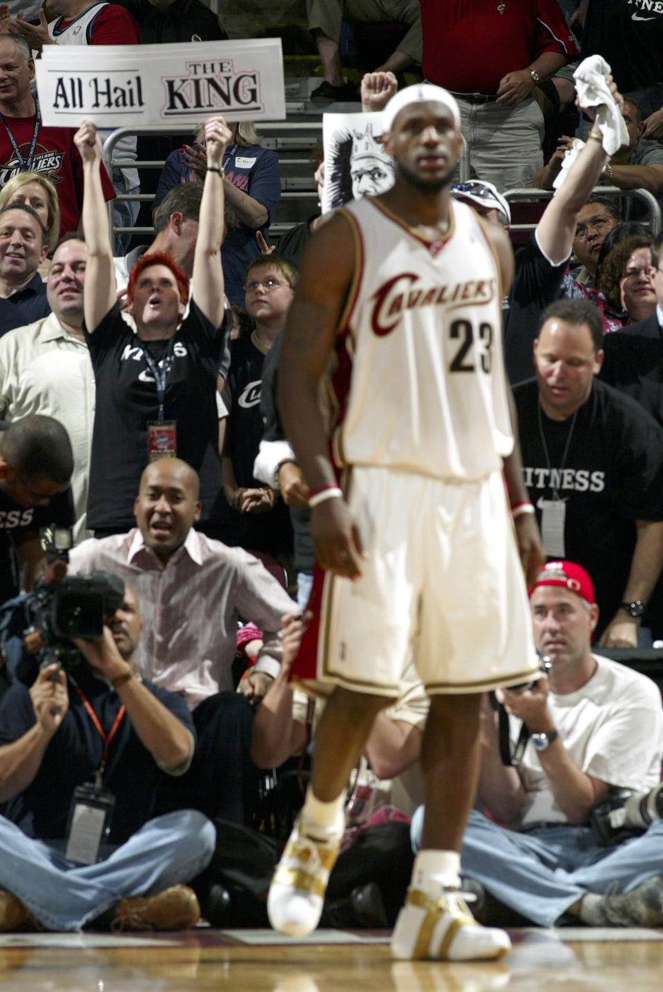 CLEVELAND, OH - APRIL 22: Fans cheer behind LeBron James #23 of the Cleveland Cavaliers in the first playoff game against the Washington Wizards in game one of the Eastern Conference Quarterfinals during the 2006 NBA Playoffs on April 22, 2006 at The Quicken Loans Arena in Cleveland, Ohio.&nbsp;