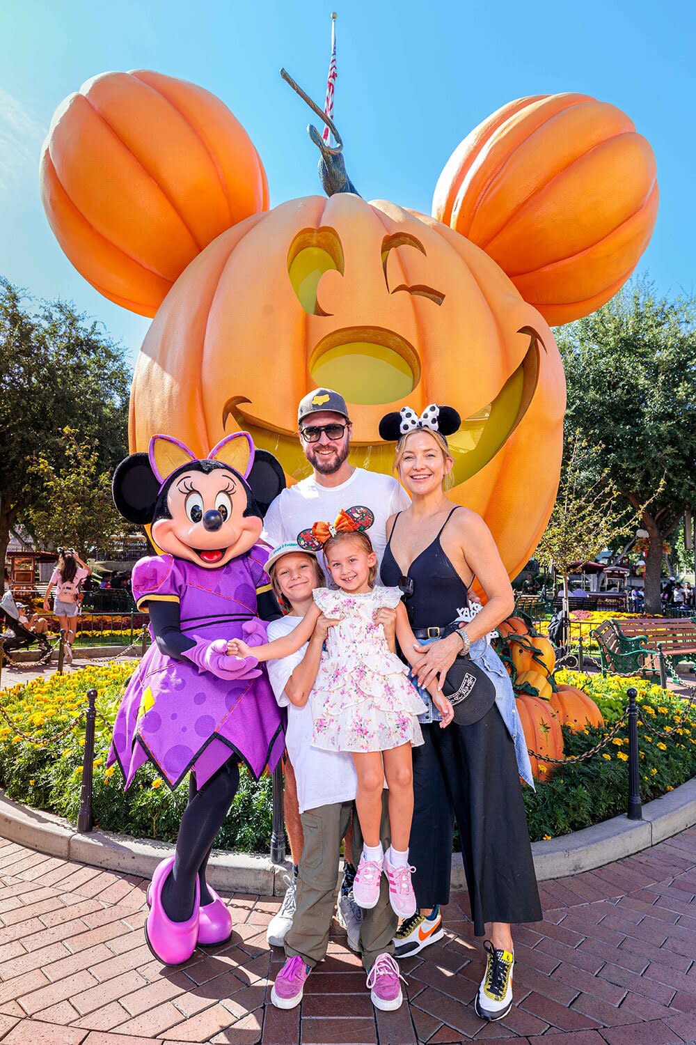 In this handout image provided by Disneyland Resort, actress Kate Hudson and her family celebrate her daughter Rani Rose's birthday with Minnie Mouse during Halloween Time at Disneyland Park on September 26, 2022 in Anaheim, California. Halloween Time casts a spell throughout Disneyland Resort with family-friendly experiences, including Haunted Mansion Holiday, Mickey Mouse pumpkin photos, favorite Cars Land characters dressed up in festive car-stumes and so much more through Oct. 31.