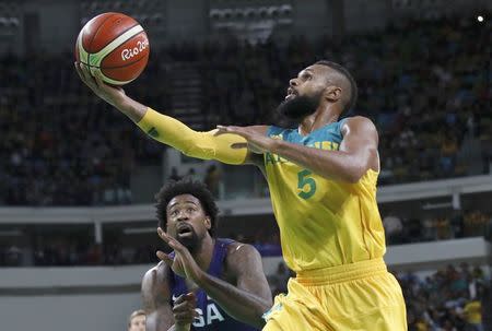 Patty Mills (AUS) of Australia and Deandre Jordan (USA) of the USA in action. REUTERS/Jim Young