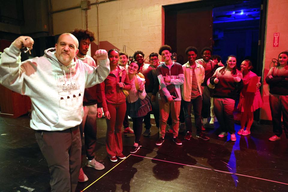 Robert Hogan, left, the drama club's advisor flexes with the cast during the Brockton High School Drama Club's dress rehearsal of "Gossip" on Friday, March 17, 2023.