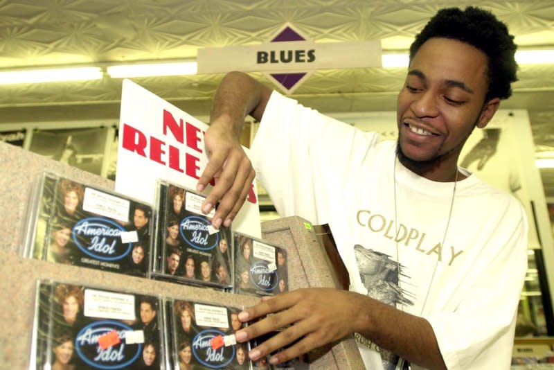 Terry Thomas, a music specialist at Streetside Records in University City, Mo.,shows off the first copies of the new American Idol compact disc on September 30, 2002. On March 2, 1983, the compact disc and player are released in the United States, beginning the slow decline of the cassette tape and launching the digital audio revolution. File Photo by Bill Greenblatt/UPI