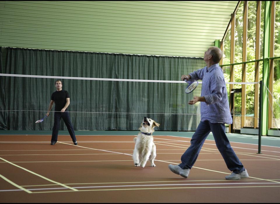 Russian President Dmitry Medvedev (back) and Putin -- and a dog -- play badminton in Sochi, Russia, on Aug. 14, 2009.