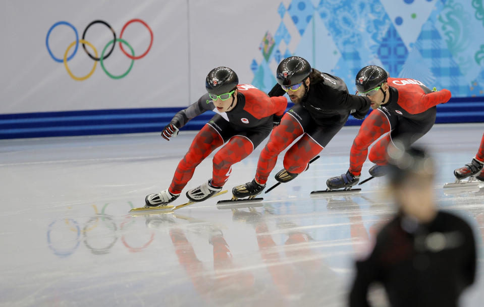 Charles Hamelin of Canada, centre, and fellow team members train during a short track speedskating practice session at the Iceberg Skating Palace ahead of the 2014 Winter Olympics, Thursday, Feb. 6, 2014, in Sochi, Russia. (AP Photo/Vadim Ghirda)
