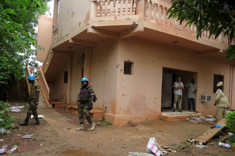 FILE PHOTO: Malian soldiers survey the damage after a hotel siege over the weekend in which 17 people died in Sevare