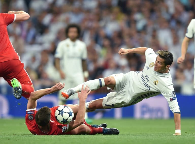 Bayern Munich's Spanish midfielder Xabi Alonso and Real Madrid's Portuguese striker Cristiano Ronaldo (right) vie for the ball during their UEFA Champions League quarterfinal match in Madrid, Spain, on April 18, 2017