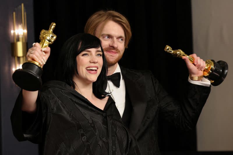 FILE PHOTO: Billie Eilish and Finneas O'Connell pose with their Oscars for Best Original Song for "No Time to Die" from the James Bond film in the photo room during the 94th Academy Awards in Hollywood, Los Angeles, California, U.S.
