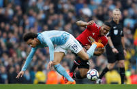 <p>Manchester United’s Antonio Valencia tangles with City’s Leroy Sane </p>