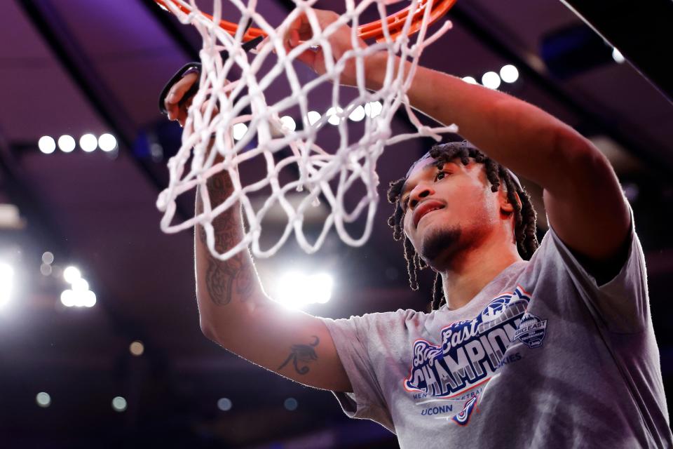 NEW YORK, NEW YORK - MARCH 16: Stephon Castle #5 of the Connecticut Huskies cuts a piece of the net after his team's win against the Marquette Golden Eagles during the Big East Basketball Tournament Final at Madison Square Garden on March 16, 2024 in New York City. The Huskies won 73-57. (Photo by Sarah Stier/Getty Images)