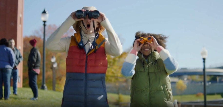 Two performers use binoculars in a birdwatching-themed ad for Amazon set in Fall River. It was filmed at Heritage State Park on the city's waterfront.