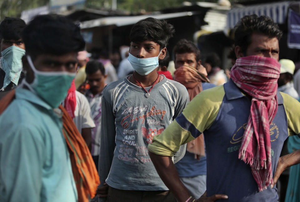 Migrant laborers from other states looking for work gather on a street on the outskirts of Jammu, India, Sunday, Sept.27, 2020. The nation of 1.3 billion people is expected to become the coronavirus pandemic's worst-hit country within weeks, surpassing the United States. (AP Photo/Channi Anand)