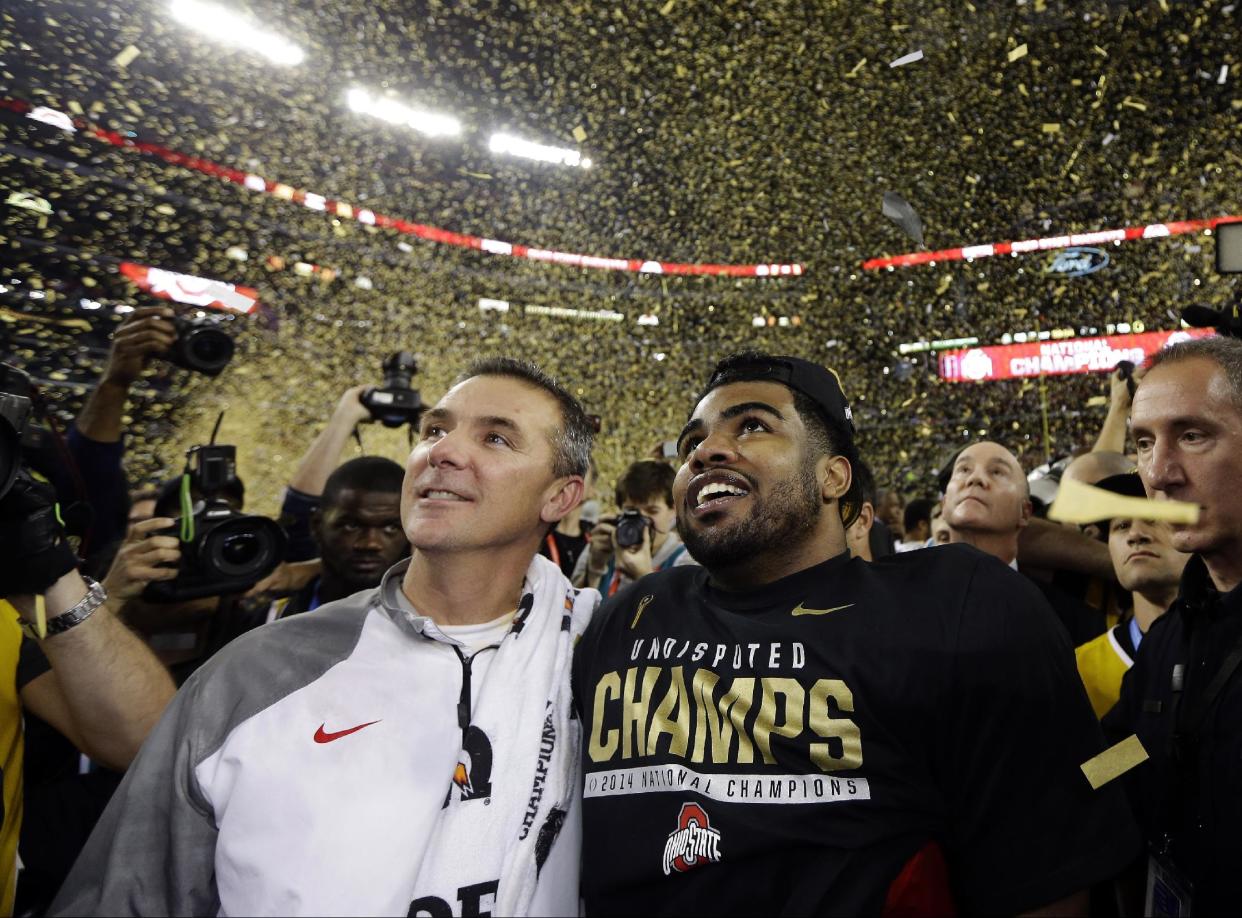 Ohio State head coach Urban Meyer and Ezekiel Elliott celebrate after the NCAA college football playoff championship game against Oregon Monday, Jan. 12, 2015, in Arlington, Texas. Ohio State won 42-20. (AP)