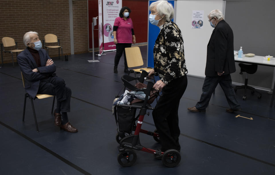 Jos Bieleveldt, 91, Ans Lock van de Veen, 91, and Okko Molenkamp, 94, from left to right, wait to be administered a COVID-19 vaccine in Apeldoorn, Netherlands, Tuesday, Jan. 26, 2021. Dutch authorities began vaccinating the first of thousands of people aged over 90 years who still live at home. (AP Photo/Peter Dejong)