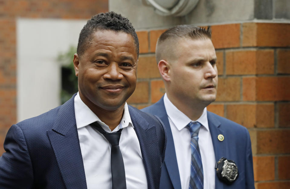 Actor Cuba Gooding Jr., left, is lead by a police officer from New York's Special Victim's Unit, Thursday, June 13, 2019. He faces allegations he groped a woman at a city night spot. A 29-year-old woman told police the 51-year-old Gooding grabbed her breast while he was intoxicated around 11:15 p.m. Sunday. Gooding denies the allegations. (AP Photo/Mark Lennihan)