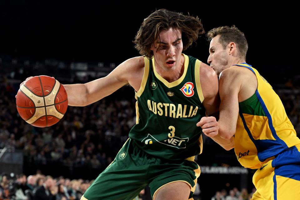 Australia’s Josh Giddey (L) drives past Brazil’s Marcelinho Huertas (R) during the international friendly basketball match between Australia and Brazil in Melbourne on August 16, 2023, in preparation for the 2023 Philippines-Japan-Indonesia FIBA Basketball World Cup. (Photo by William WEST / AFP) / –IMAGE RESTRICTED TO EDITORIAL USE – STRICTLY NO COMMERCIAL USE– (Photo by WILLIAM WEST/AFP via Getty Images)