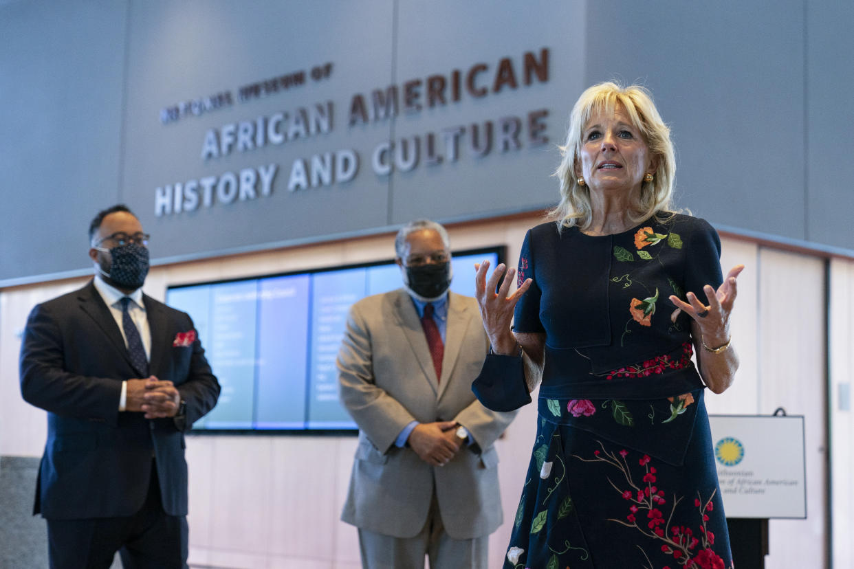 First lady Jill Biden speaks to gathered employees and media during a visit to the National Museum of African American History and Culture with Lonnie Bunch, Secretary of the Smithsonian, center, and National Museum of African American History and Culture director Kevin Young, left, Friday, May 14., 2021, in Washington. (Carolyn Kaster/AP)