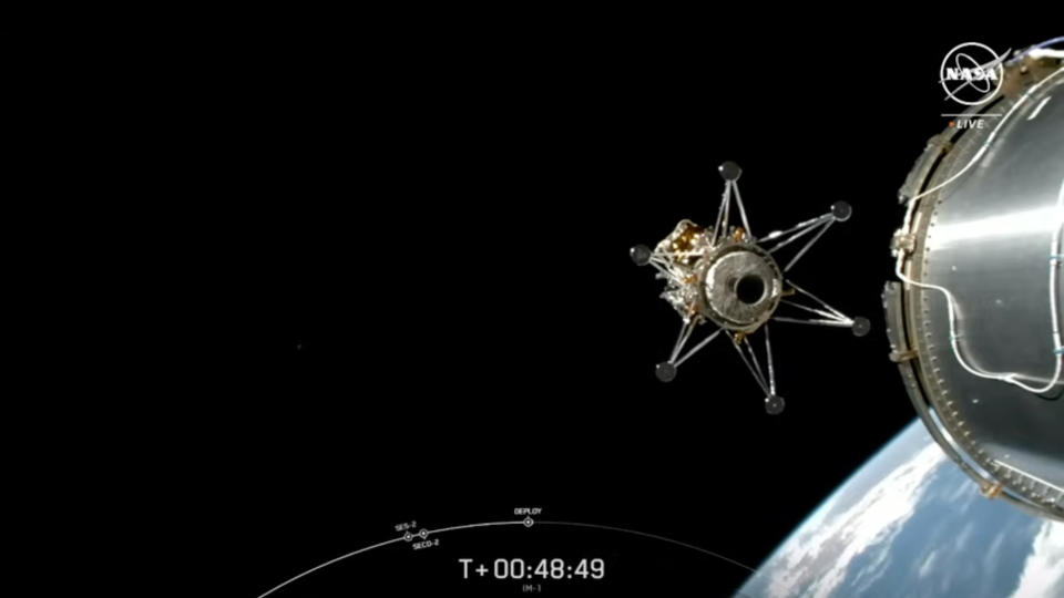 a spacecraft deploys from a rocket's upper stage, with the curve of earth and the blackness of space in the background.