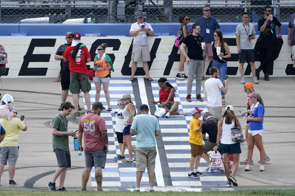 Fans take pictures at the start/finish line at Nashville Superspeedway before a NASCAR Cup Series auto race Sunday, June 26, 2022, in Lebanon, Tenn. (AP Photo/Mark Humphrey)