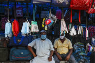 Face masks hang at a roadside stall for sale in Kolkata, India, Friday, Aug. 14, 2020. India's coronavirus death toll overtook Britain's to become the fourth-highest in the world with another single-day record increase in cases Friday. (AP Photo/Bikas Das)