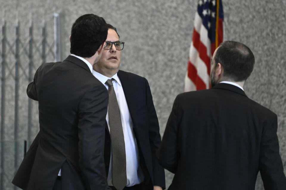 Derrel McDavid, center, walks into the Dirksen Federal Courthouse in Chicago after verdicts were reached in R. Kelly's trial, Two Kelly associates, Derrel McDavid and Milton Brown, are co-defendants. McDavid is accused of helping Kelly fix the 2008 trial,, Wednesday, Sept. 14, 2022, in Chicago. A federal jury on Wednesday convicted R. Kelly of several child pornography and sex abuse charges in his hometown of Chicago, delivering another legal blow to a singer who used to be one of the biggest R&B stars in the world. (AP Photo/Matt Marton)