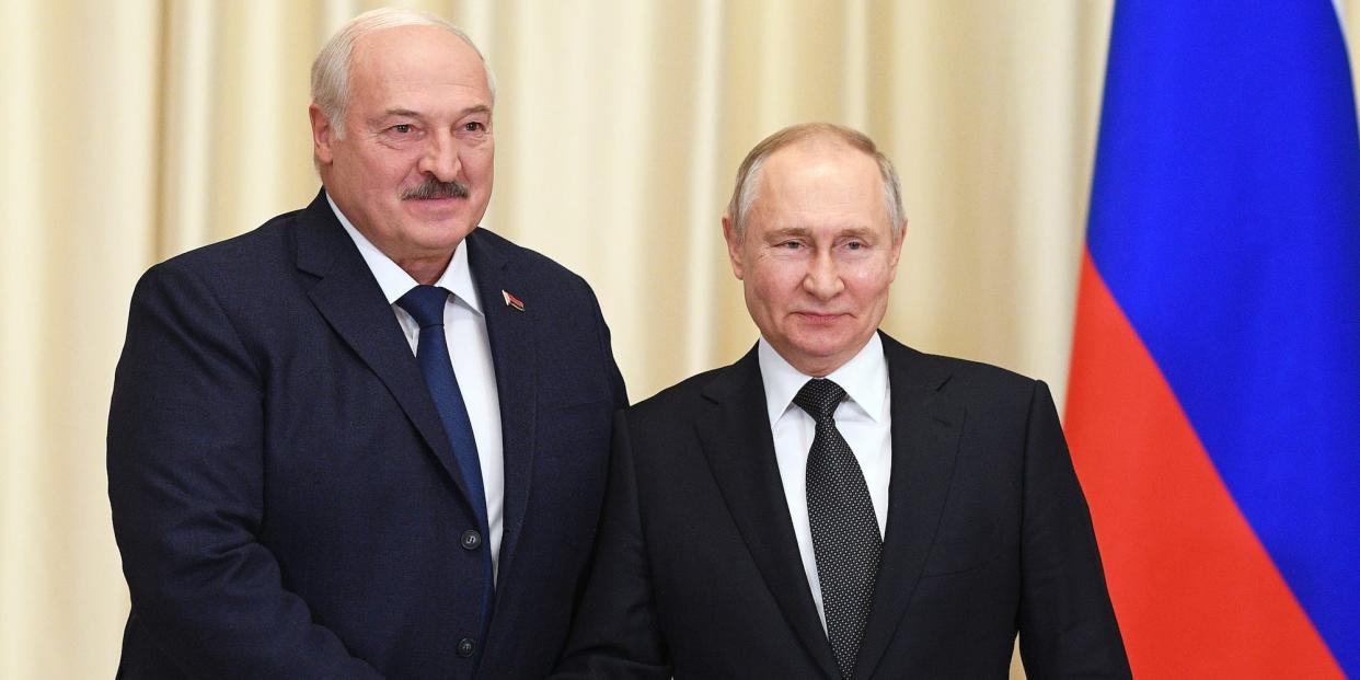 Russian President Vladimir Putin, right, and Belarusian President Alexander Lukashenko shake hands during their meeting at the Novo-Ogaryovo state residence, outside Moscow, Russia, Friday, Feb. 17, 2023