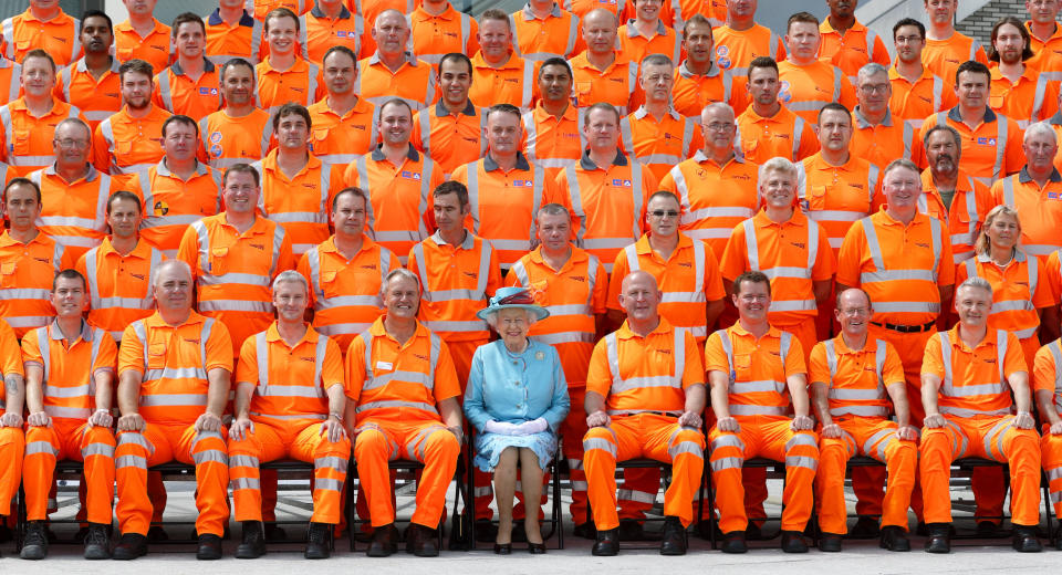Queen Elizabeth II poses for a group photograph with Network Rail construction workers after opening the newly redeveloped Reading Railway Station on July 17, 2014 in Reading, England.